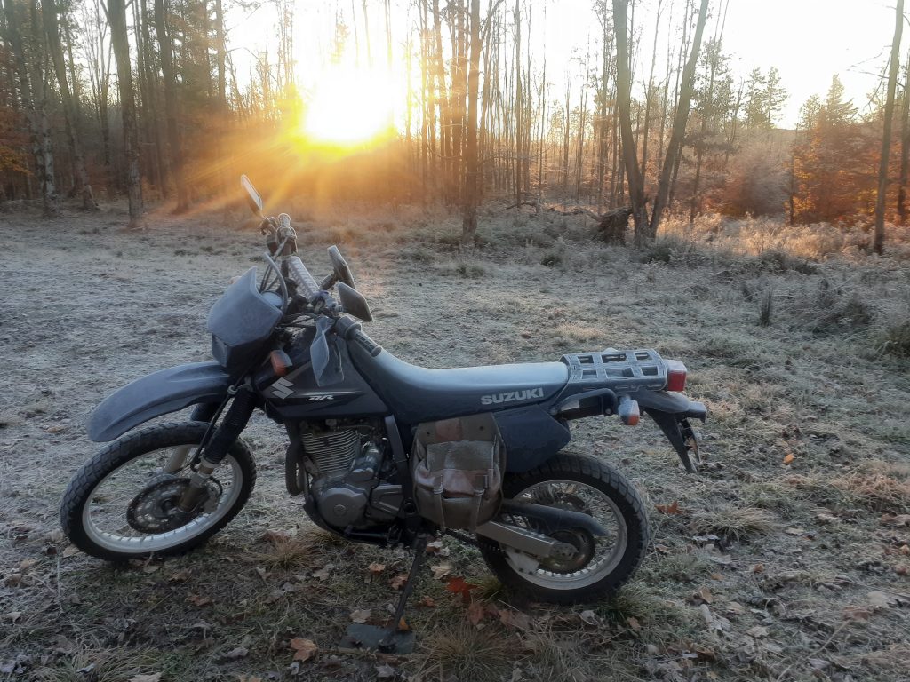 A frost covered DR650 moto camping